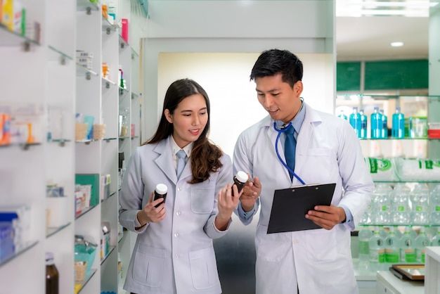 Pharmacists verifying medication accuracy against records